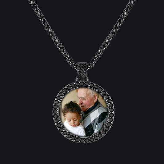 A black oxidized metal pendant necklace featuring a custom circular photo insert of an elderly man and child.img