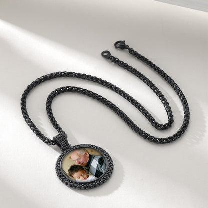 A black wheat chain with a circular custom photo pendant.