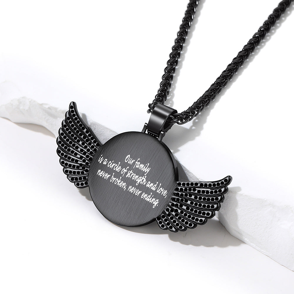 A black metal pendant necklace with engraved white text and wing-shaped side details