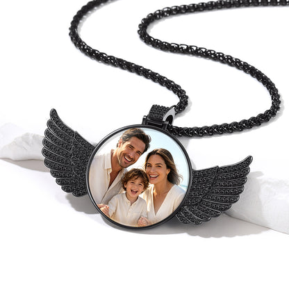 A black wing pendant necklace with a custom circular photo insert.