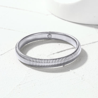 Close-up view of polished stainless steel stretch chain bangle links