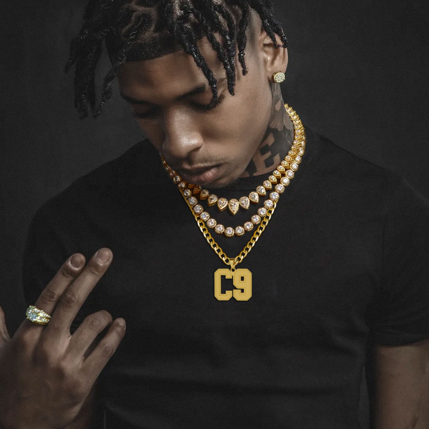 Man wearing gold Initial Letter Necklace with a dark background