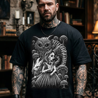 A man wearing a black graphic t-shirt featuring a detailed black and white illustration of Alice in Wonderland with the Cheshire Cat, mushrooms, and a skeleton, set against a dark, atmospheric bookshelf background.