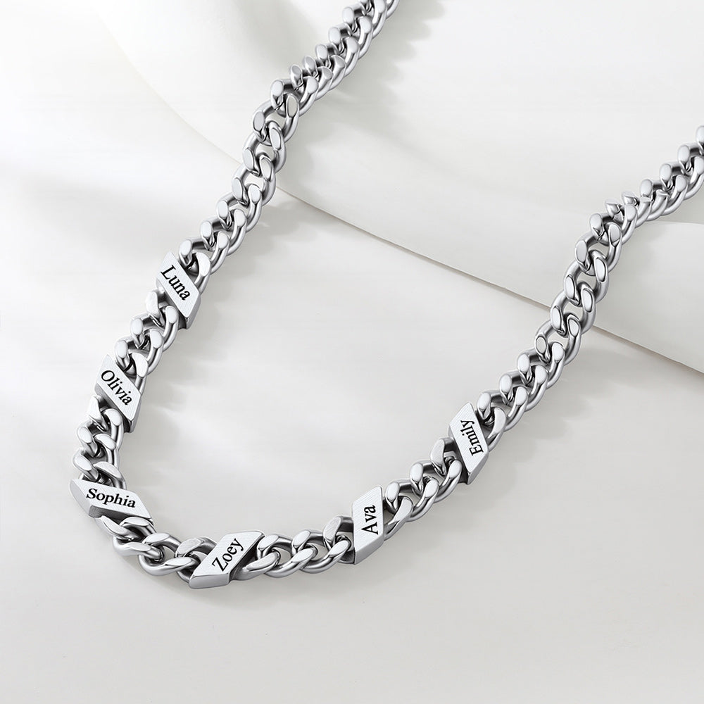 Silver chain necklace with engraved names on a white background