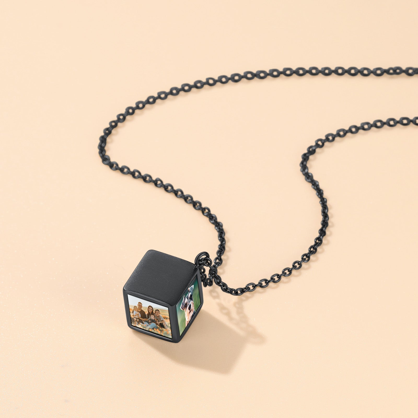 Black chain necklace with a cube pendant on a beige background