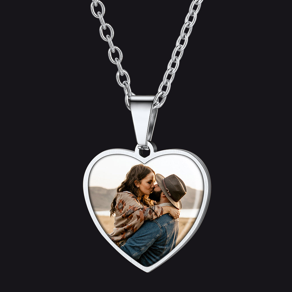 Heart-shaped pendant with a photo of a couple on a black background