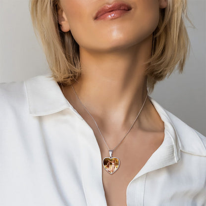Heart-shaped necklace worn by a person with a plain background