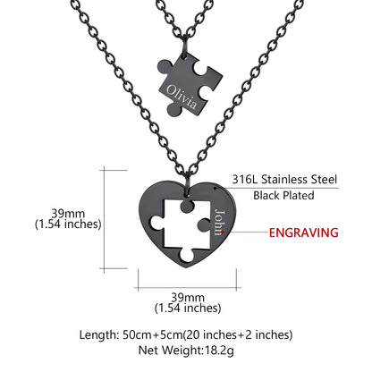 Black stainless steel puzzle piece heart necklace with engraved names on a white background