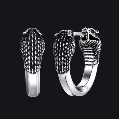 Silver hoop earrings with snake head design on a black background
