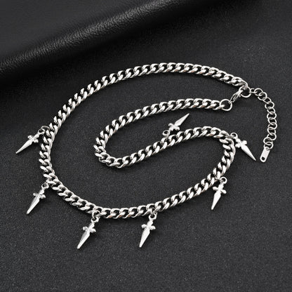 Silver chain anklets with spike charms on a dark surface