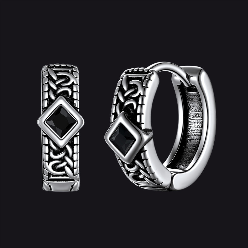 Silver hoop earrings with black gemstones on a black background