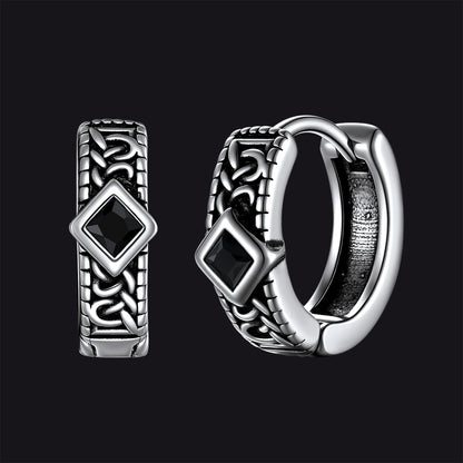 Silver hoop earrings with black gemstones on a black background