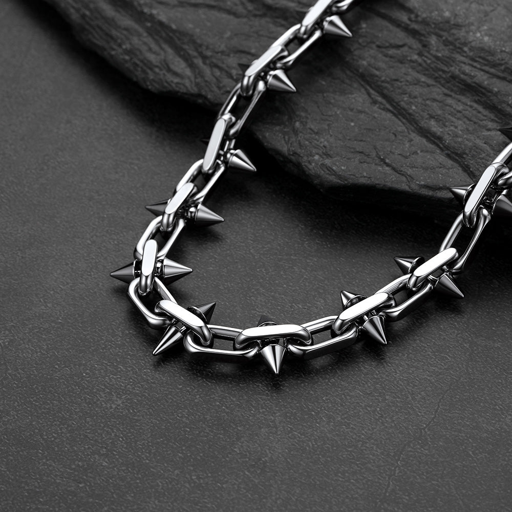 A close-up of a Gothic punk thorn cone spike heavy chain necklace for men