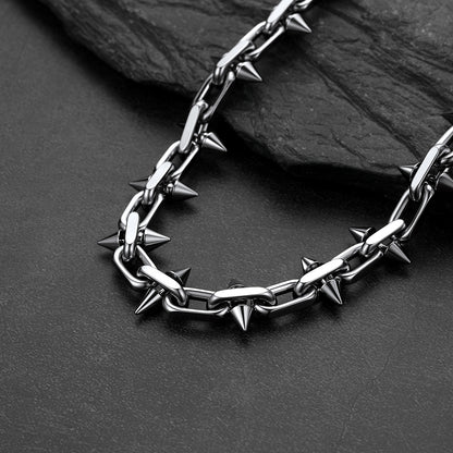 A close-up of a Gothic punk thorn cone spike heavy chain necklace for men