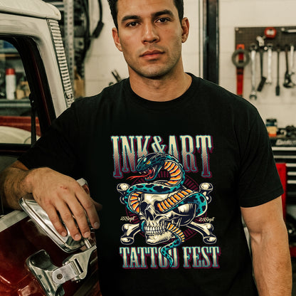 Man wearing a black t-shirt with a tattoo-themed design in a garage setting