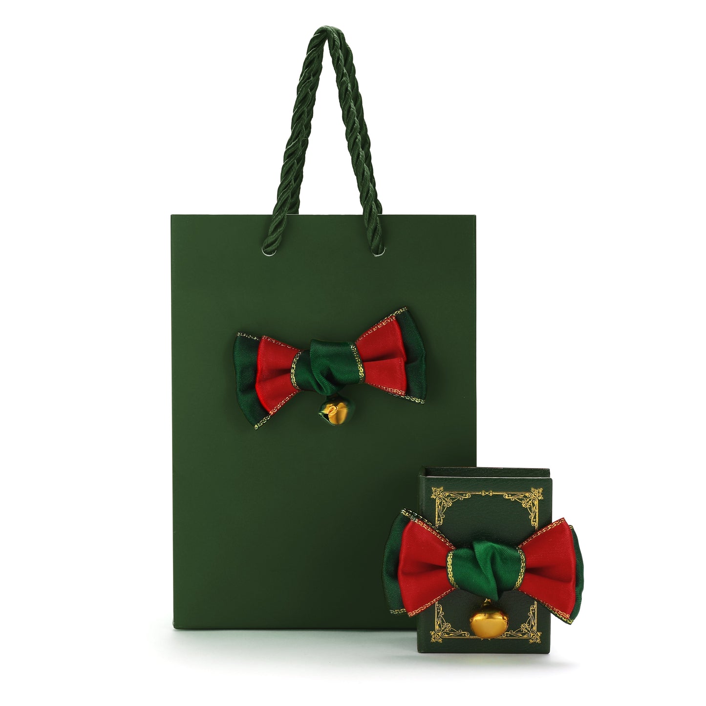 Green gift bag with red and green bow and gold bell on a white background