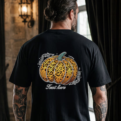 A man viewed from behind wearing a black t-shirt with a large graphic of a leopard-print pumpkin.