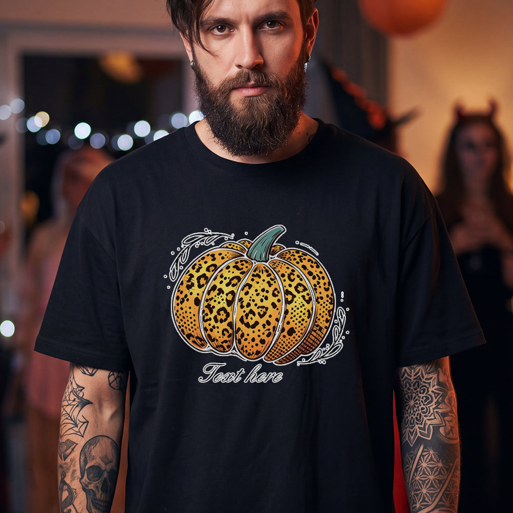 A man wearing a black T-shirt with a graphic of a leopard-print pumpkin and the text.