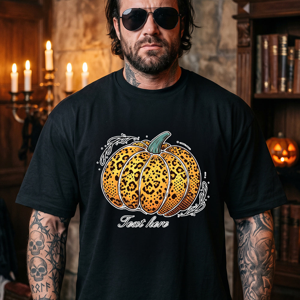 A man wearing a black graphic t-shirt with a leopard-print pumpkin design and the text.