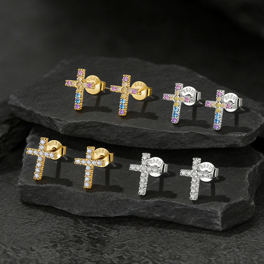 Set of cross-shaped earrings with colorful gemstones on a dark stone surface in Different Colors