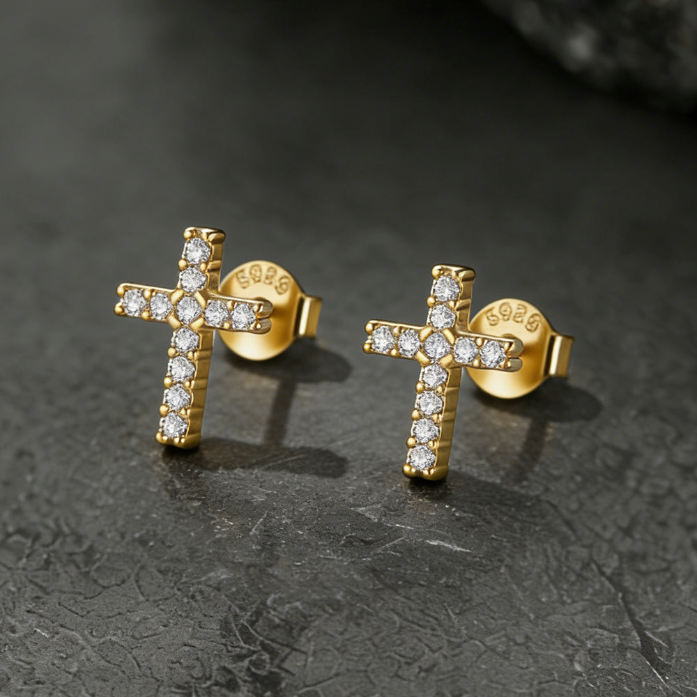 Gold cross earrings with diamond accents on a dark textured surface for Women, Ladies