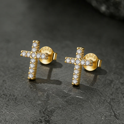 Gold cross earrings with diamond accents on a dark textured surface for Women, Ladies