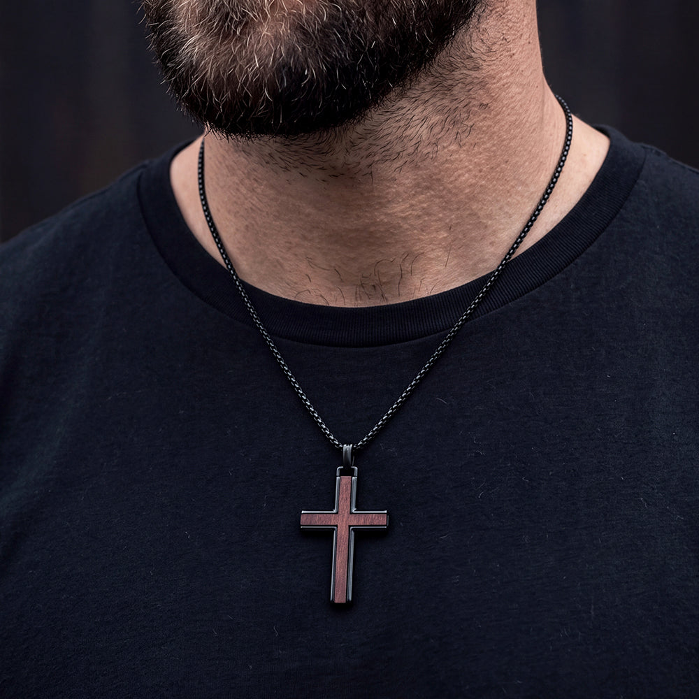 Man styling black wood inlay cross necklace with casual shirt