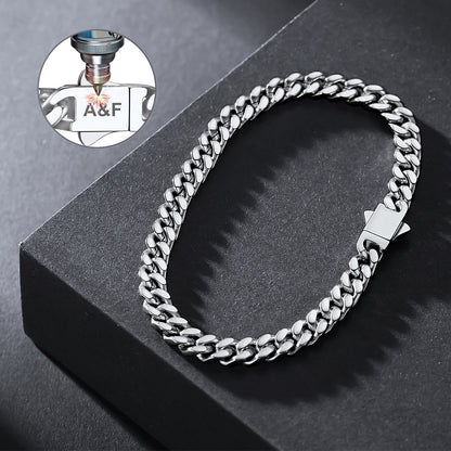 Silver chain bracelet on a dark surface with a close-up of a bottle label in the corner.