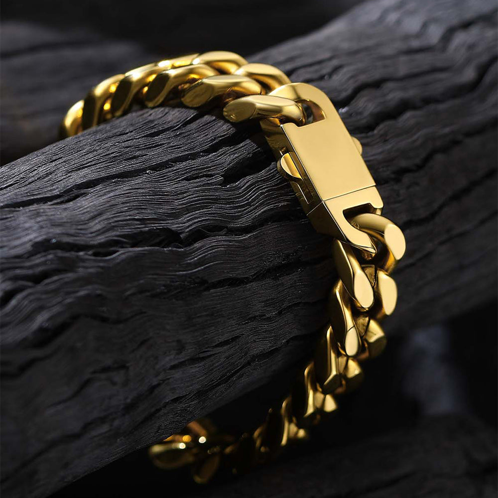 Gold chain bracelet on a textured black surface
