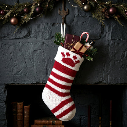 A festive Christmas stocking hanging in front of a dark fireplace. 