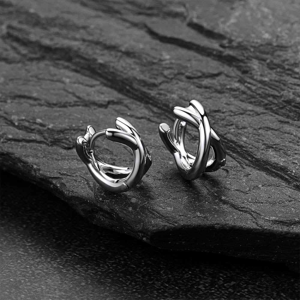 A Pair of silver hoop earrings on a dark stone surfaceMinimalism X-Structure Hoop Earrings for Men
