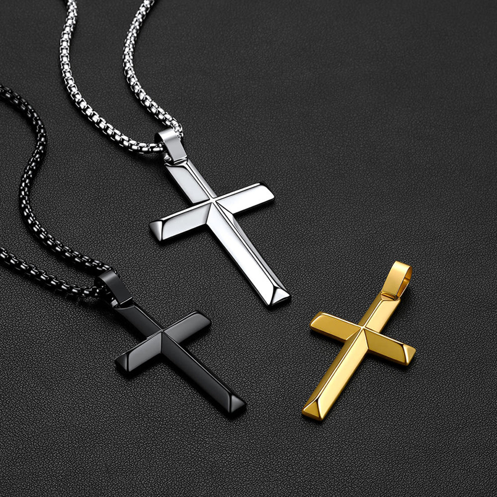 Three cross pendant necklaces on chains, shown on a dark textured background.