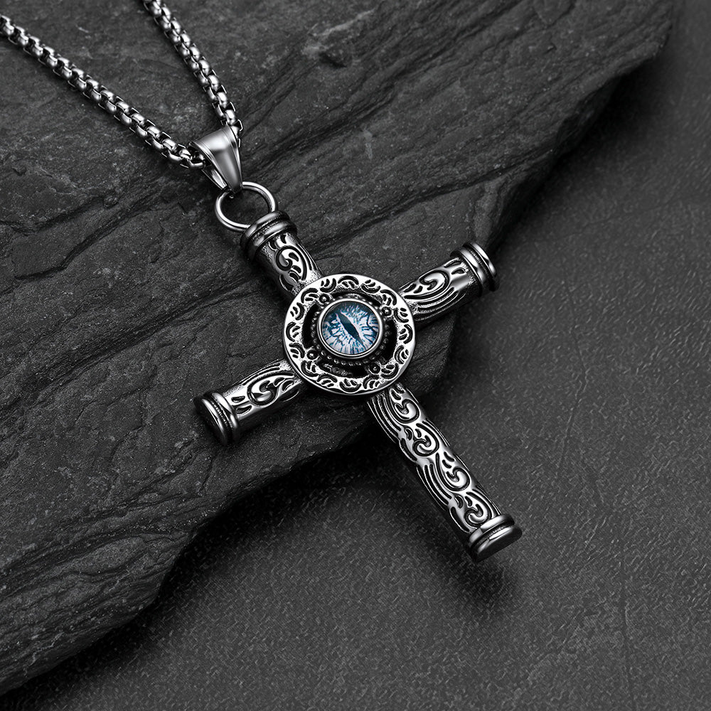 Close-up of evil eye motif and runic carving on cross pendant