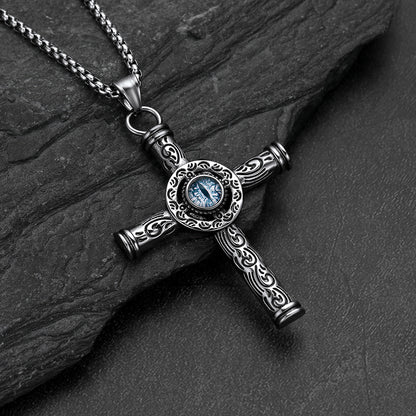 Close-up of evil eye motif and runic carving on cross pendant