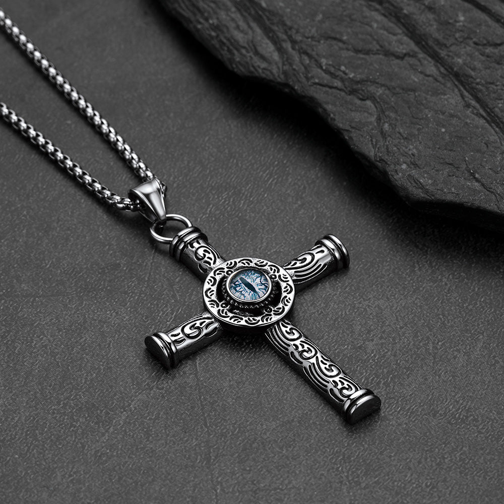 Close-up of evil eye motif and runic carving on cross pendant