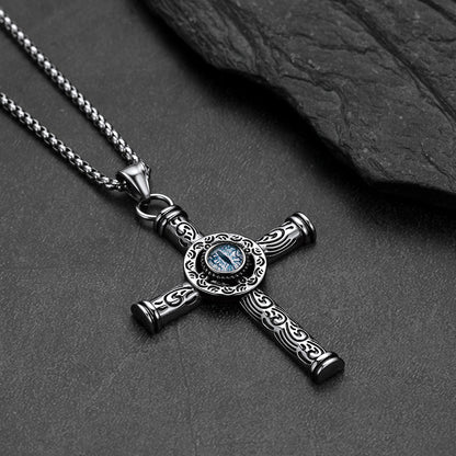 Close-up of evil eye motif and runic carving on cross pendant