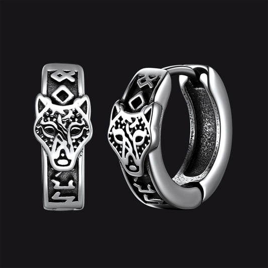 Silver hoop earrings with wolf head design on a black backgroundimg