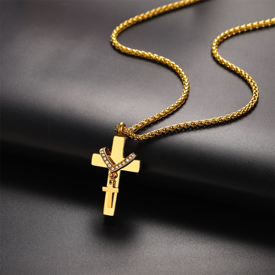 Gold cross pendant necklace on a dark background