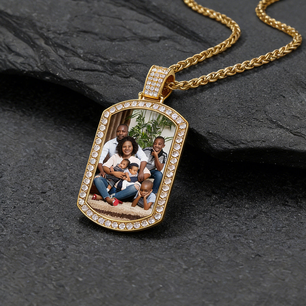 Gold picture pendant with family photo on a dark stone surface