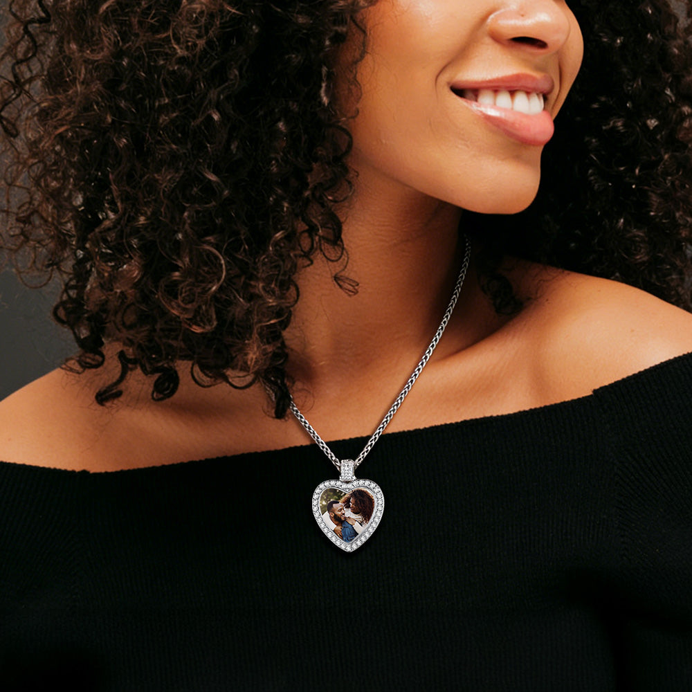 Woman wearing a necklace with a heart-shaped pendant featuring an image of a couple.