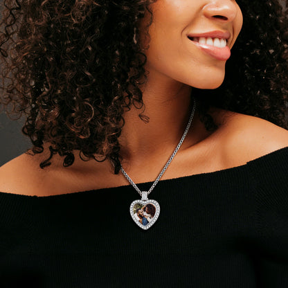 Woman wearing a necklace with a heart-shaped pendant featuring an image of a couple.
