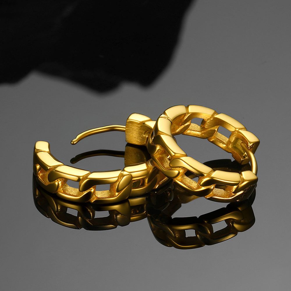 Pair of gold hoop earrings on a reflective surface with a dark background