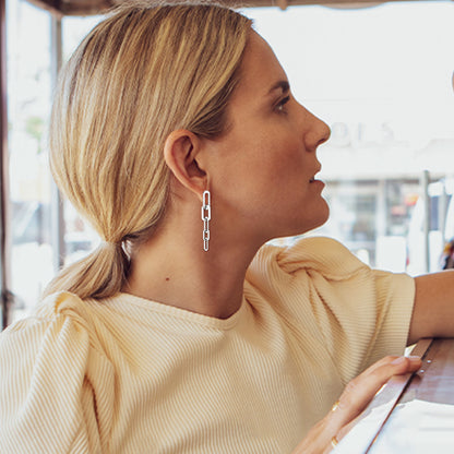 Woman Wearing Long Steel Cuban Chain Earrings