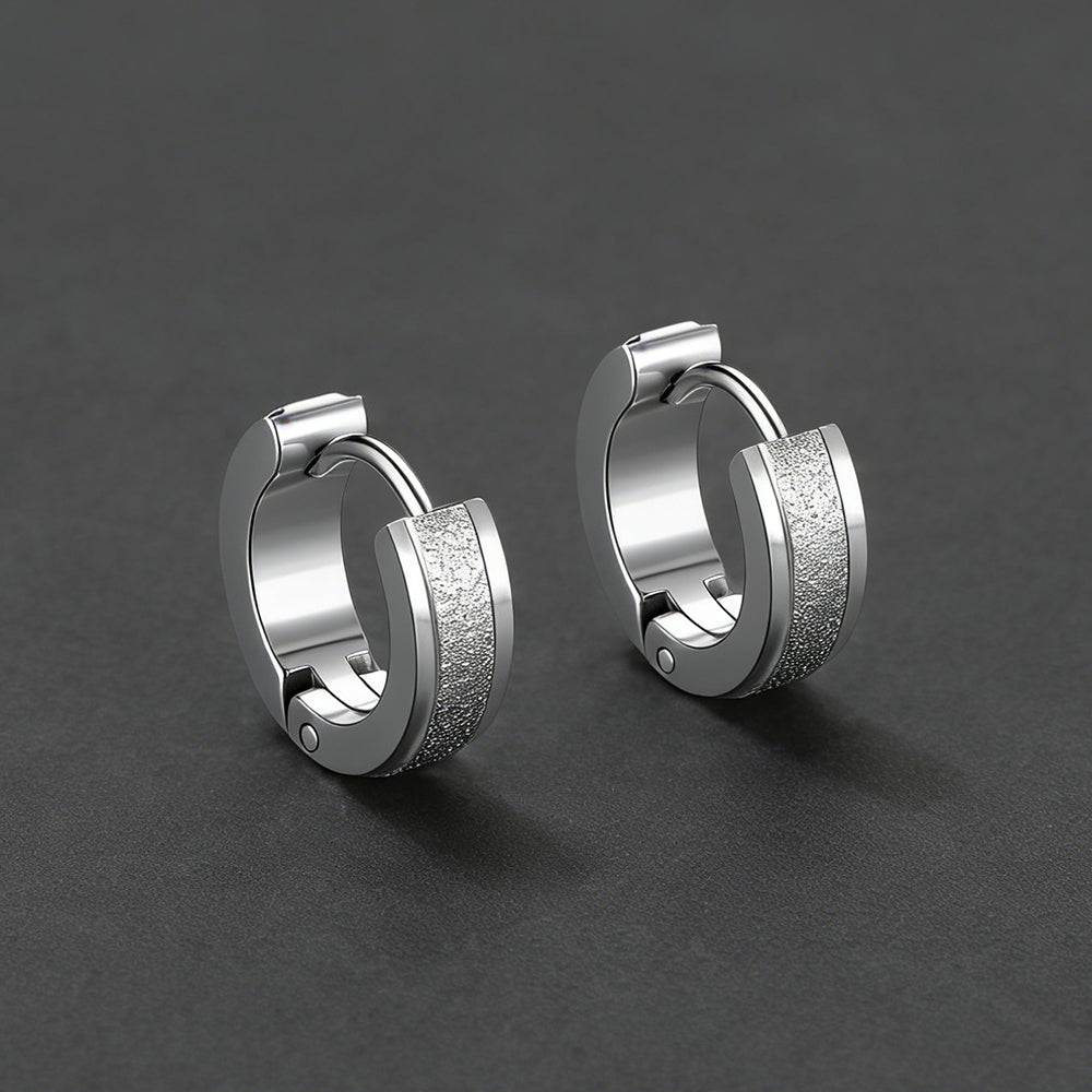 Pair of silver hoop earrings on a dark gray background