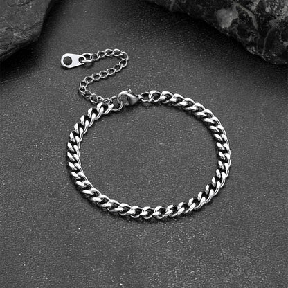 Silver chain bracelet on a dark surface