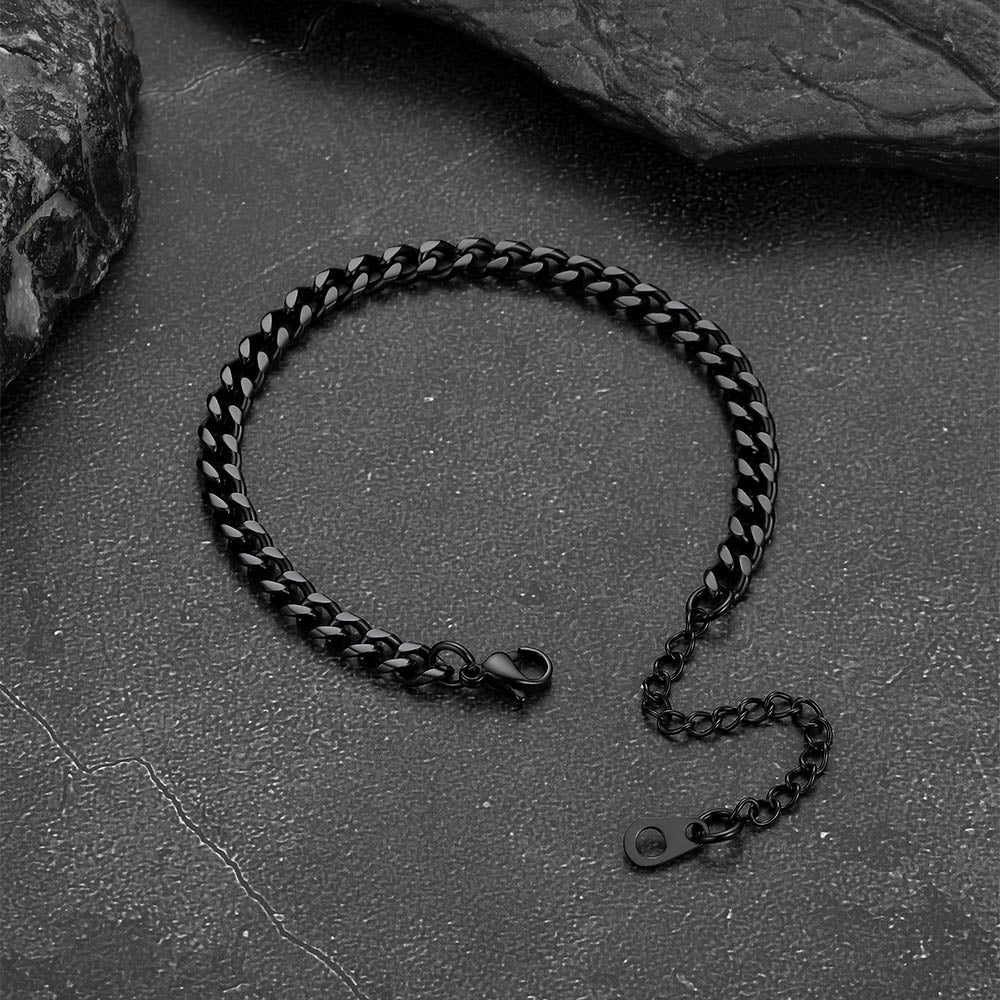 Black chain bracelet on a textured stone surface