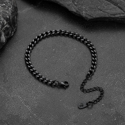Black chain bracelet on a textured stone surface
