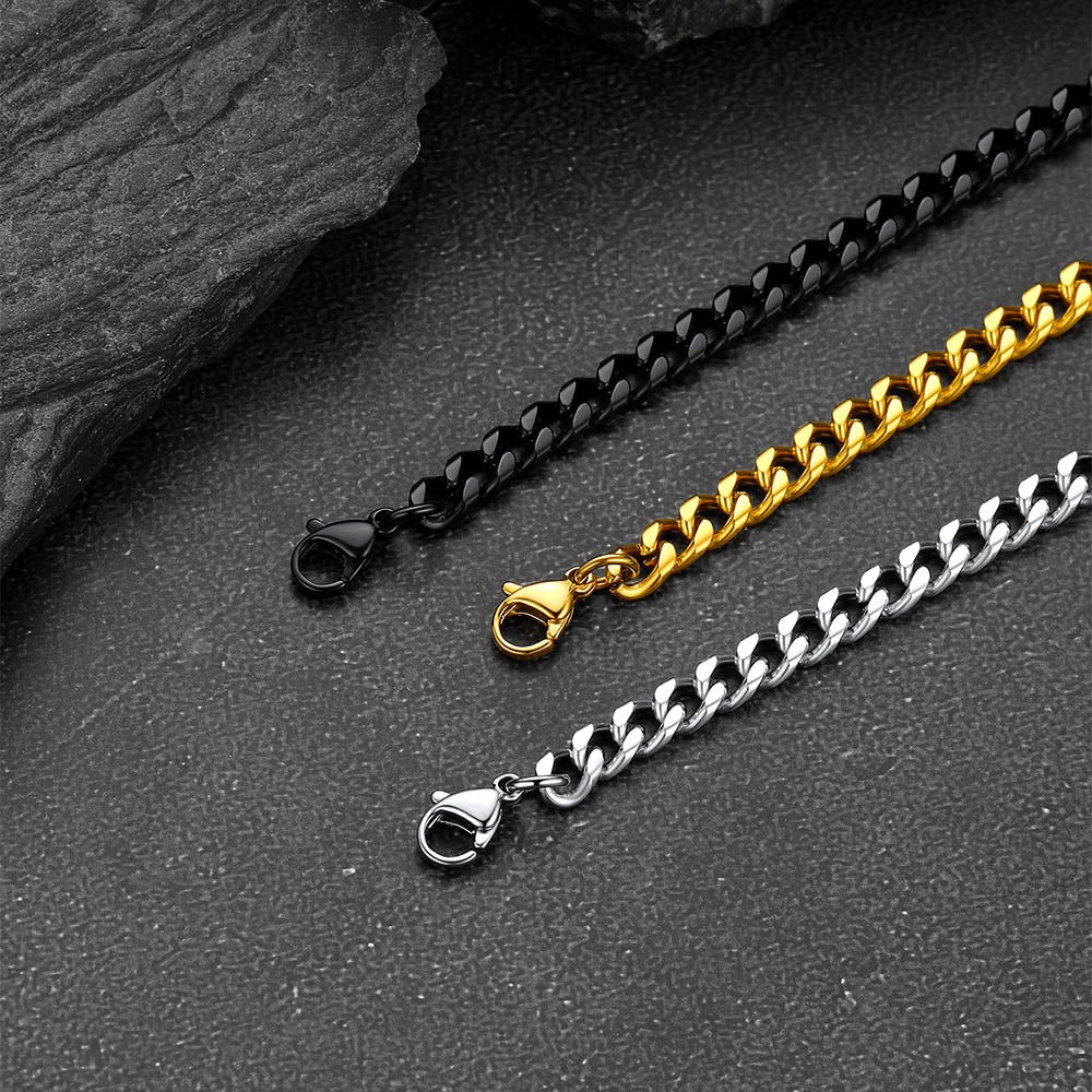 Three chain necklaces in black, gold, and silver on a dark surface.