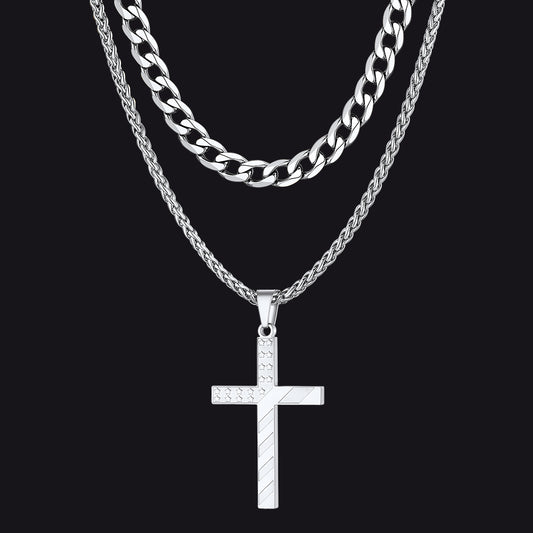 Silver chain necklace with a cross pendant on a black backgroundimg