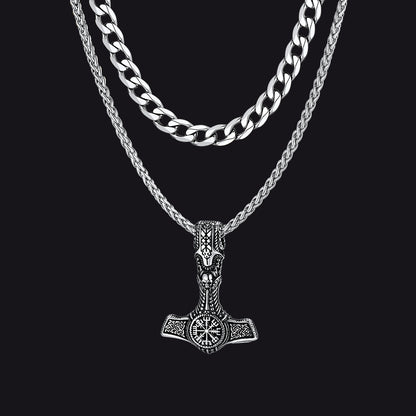 Cuban chain and Thor’s hammer pendant necklaces on flat lay with Viking props.